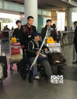吴京手拿拐杖坐轮椅现身机场 表情严肃疑似腿受伤